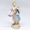 Meissen Figurine Of A Lady Holding A String Of Flowers