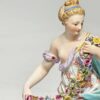 Meissen Figurine Of A Lady Holding A String Of Flowers