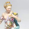 Meissen Figurine Of A Lady Holding A String Of Flowers