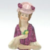 Porcelain Glazed 20th Century Half Doll Holding Yellow Flower
